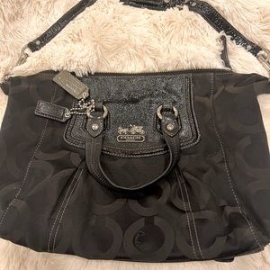 Coach black logo shoulder bag with patent leather straps.